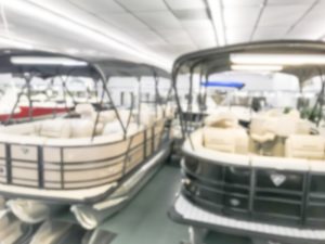 Motion blurred inside a large boat dealer selling variety of new and used boats